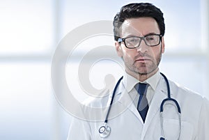 Portrait of a smiling doctor in a bright room of the clinic