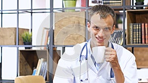 portrait of smiling doctor having a coffee break in the staff room