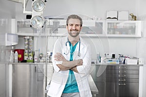 Portrait of smiling doctor standing with arms crossed at veterinary clinic