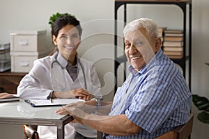 Portrait of smiling elderly male patient at consultation in clinic