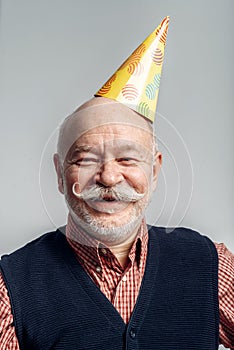 Portrait of smiling elderly man in cap