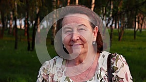 Portrait of a smiling elderly woman in the park