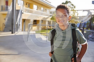 Portrait of smiling elementary school boy with his backpack