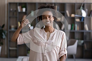 Portrait of smiling ethnic woman renter show house keys