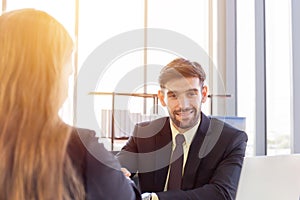 Portrait of a smiling European men entrepreneur handshake with his female business partner, two successful people congratulate