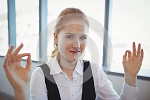 Portrait of smiling executive performing yoga