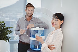 Portrait of smiling executives holding glasses of water