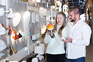 Portrait of smiling family choosing nightlight in shop