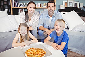 Portrait of smiling family with pizza