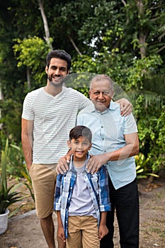 Portrait of smiling family standing against plants