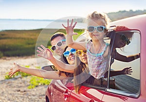 Portrait of a smiling family with two children at beach in the c