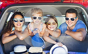 Portrait of a smiling family with two children at beach in the c