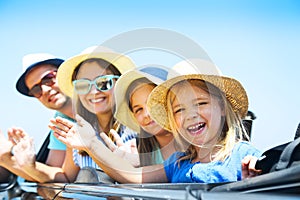 Portrait of a smiling family with two children at beach in the c