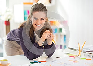 Portrait of smiling fashion designer in office