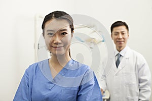 Portrait Of Smiling Female Dental Assistant In Clinic