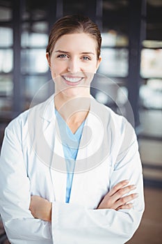 Portrait of smiling female doctor with arms crossed