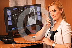 Portrait of a smiling female doctor sitting at work desk