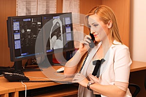 Portrait of a smiling female doctor sitting at work desk