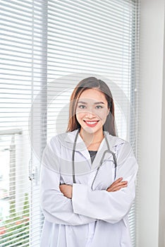 Portrait of smiling female doctor standing posing in her hospital office., Healthcare and medical occupation concept