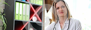 Portrait of smiling female doctor with stethoscope in clinic