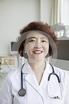 Portrait of smiling female doctor with a stethoscope looking at camera