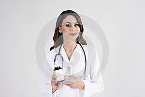 Portrait of smiling female doctor with stethoscope and medicament