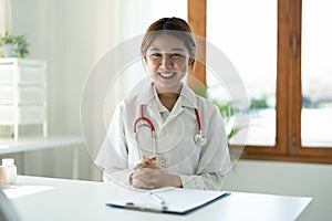 Portrait Of Smiling Female Doctor With Stethoscope Sitting in clinic
