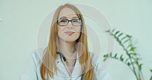 Portrait Of Smiling Female Doctor Wearing White Coat With Stethoscope In Hospital Office.