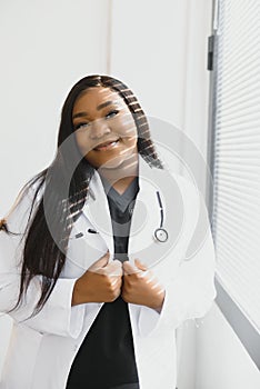 Portrait Of Smiling Female Doctor Wearing White Coat With Stethoscope In Hospital Office.