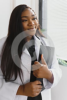 Portrait Of Smiling Female Doctor Wearing White Coat With Stethoscope In Hospital Office.