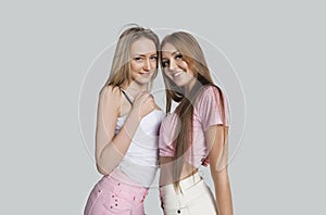 Portrait of smiling female friends against white background