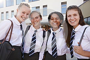 Portrait Of Smiling Female High School Students Wearing Uniform Outside College Building photo