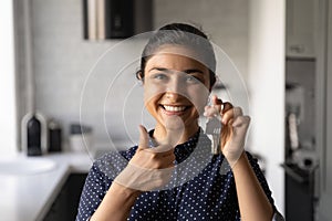 Portrait of smiling female Indian renter with keys