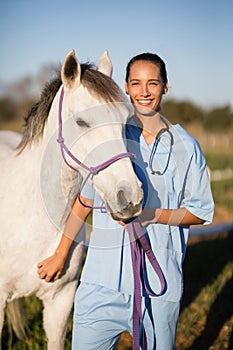 Portrait smiling female vet by horse