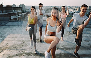 Portrait of smiling fit happy people doing power fitness exercise