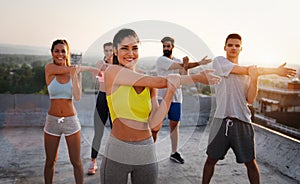 Portrait of smiling fit happy people doing power fitness exercise