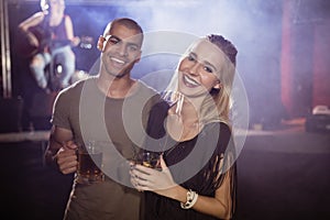 Portrait of smiling friends holding beer glasses