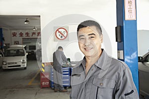 Portrait of Smiling Garage Mechanic at Work