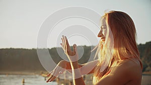 Portrait smiling girl in bikini enjoying by ocean on beach vacation.