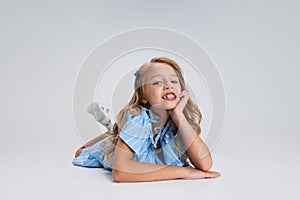 Portrait of smiling girl in casual clothes isolated on white studio background. Happy childhood concept. Sunny child