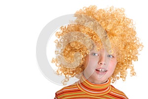 Portrait of smiling girl in curly wig.