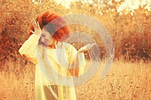 Portrait of a smiling girl dressed in raincoat.