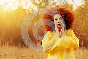 Portrait of a smiling girl dressed in raincoat.