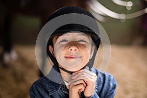 Portrait of smiling girl fastening helmet