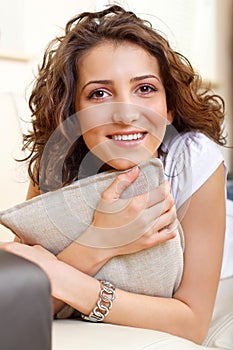 Portrait of a smiling girl holding a pillow