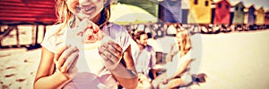 Portrait of smiling girl holding watermelon with parents in background