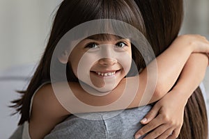 Portrait of smiling girl hug cuddle with young mom