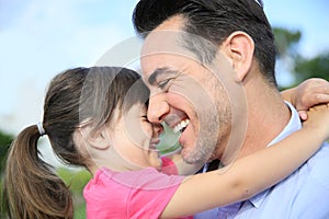 Portrait of smiling girl hugging her father