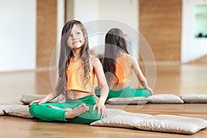 Portrait of smiling girl practicing yoga, sitting in Padmasana exercise, working out wearing sportswear photo