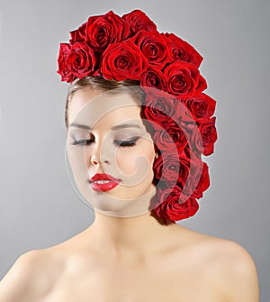 Portrait of smiling girl with red roses hairstyle